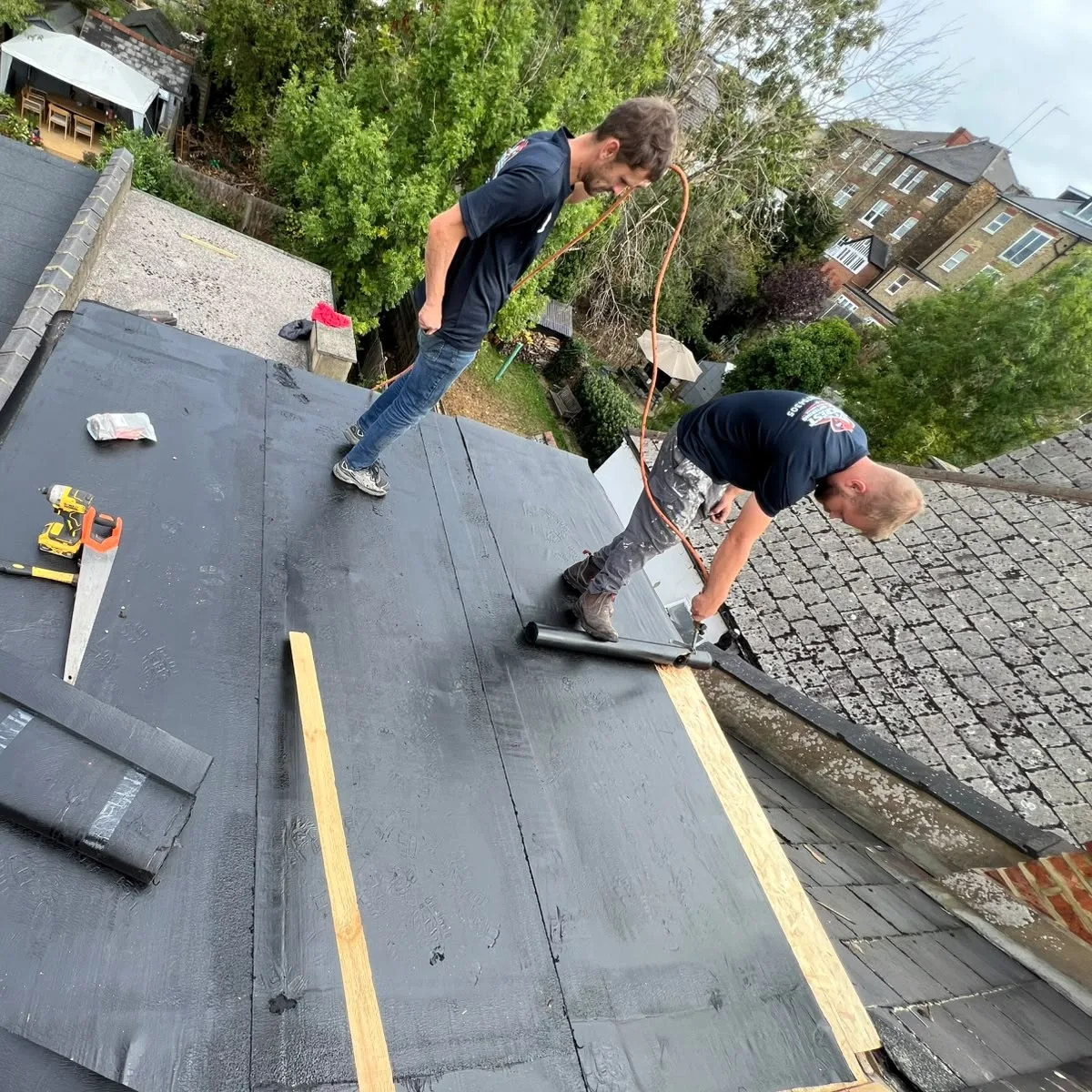 Team felting a flat roof